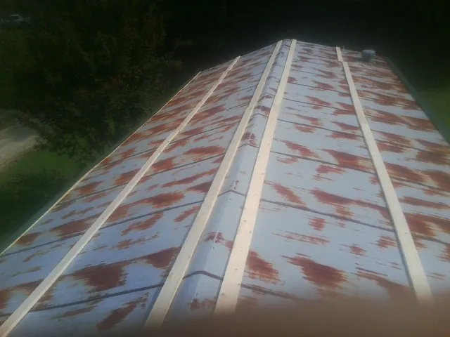 Rusted metal roof panels with new wood purlins before replacement — Storm Damage Roof Repair in Kennesaw by Roofing Brothers