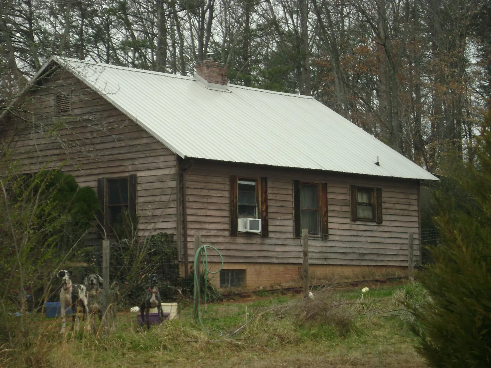 White metal roof on an old wood sided farmhouse, from a Asphalt Shingle Roof Repair job in Kennesaw